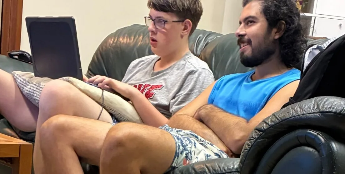 Two residents relaxing together on a leather lounge